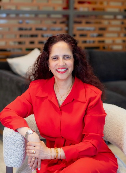 Dilzeen Engineer, DFW realtor, seated and smiling warmly